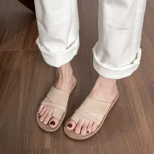 Minimalist beige leather thong sandals with suede strap and contrast stitching on the sole