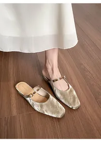 Detailed view of champagne gold velvet square-toe mule with amber bead strap