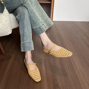 French vintage yellow woven mule with square toe and buckle strap on wooden floor