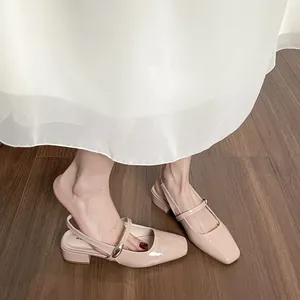 Elegant beige patent leather Mary Jane sandals with block heels and gold ring buckles