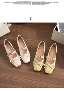 Close-up of Mary Jane flat shoes with bow details and square toe on wooden floor