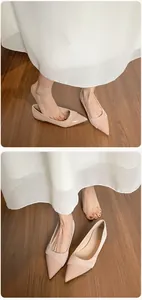 Close-up of nude pink pointed flats with patent leather toe and soft suede texture