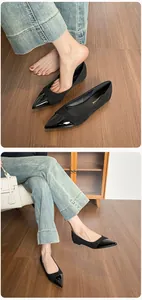 Detail of pointed toe flat shoes with glossy patent leather and matte suede patchwork design