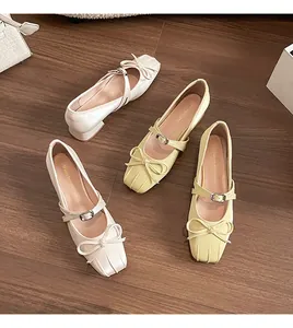 Detail of square toe Mary Jane pumps with elegant bow and adjustable ankle strap