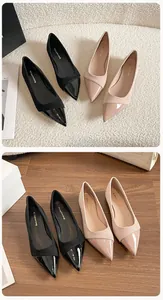 Detail view of stylish pointed-toe flats in black and nude with mixed leather textures