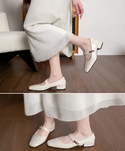 Detailed view of cream Mary Jane shoes with square toe and low block heel on model