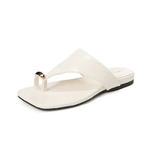 Minimalist cream-colored toe-loop flat sandals with elegant gold bead decoration