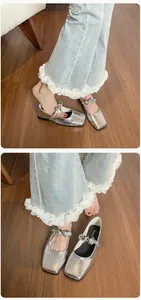 Detail of silver square toe ballet flat featuring a floral rhinestone buckle strap