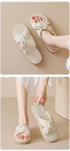 Detailed macro view of beige criss-cross straps and padded insole of flat slide sandals