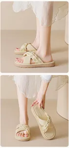 Detail of cream platform slide sandals with twisted knot straps and soft textured leather