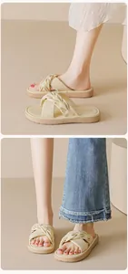 Close-up of beige platform slide sandals featuring a wide twisted knot strap design