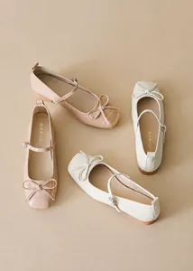 Detail of square toe Mary Jane shoes featuring delicate bows and adjustable metal buckles