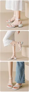 Detailed view of women's silver rhinestone sandals with square block heels and buckle straps