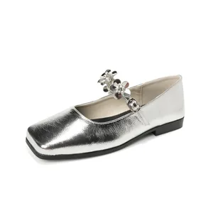 Silver square-toe Mary Jane flats with sparkly rhinestone floral buckles on white background