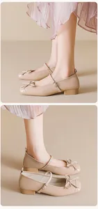 Detail of beige Mary Jane shoes featuring a bow ornament and low block heel style