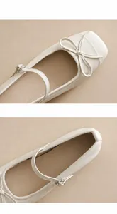 Detail of off-white Mary Jane flats featuring a delicate bow and textured leather