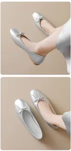 Detailed shot of silver bow ballet flats featuring metallic finish and soft rubber soles