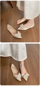 Detalle macro de bailarinas champagne de punta con lazo de satén y decoración de strass