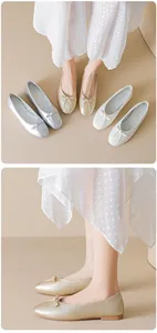 Detailed view of silver and gold ballet flats featuring delicate bow accents on top