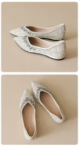 Detail of square-toe flat shoes with ivory satin and embellished pearls and rhinestones