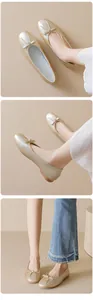 Detailed close-up of champagne gold ballet flats with bow decoration and textured finish