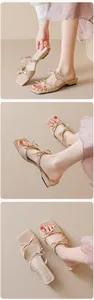 Detail of square-toe slide sandals with double bow decoration in elegant beige finish