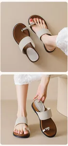 Detail of French vintage toe-loop sandals with beige suede straps and metal buckles