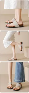 Close-up of women's suede slide sandals with metallic toe ring and thick rubber sole