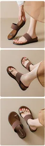 Detailed view of brown matte flip-flop sandals with metallic buckle and platform sole