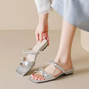 Silver bow square toe block heel sandals with metallic finish and open-toe design