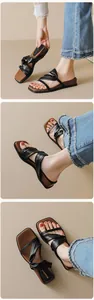 Detail of square toe platform sandals featuring black knotted straps and leather footbed