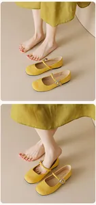 Close-up of yellow Mary Jane flats with suede patchwork and silver metal buckle straps