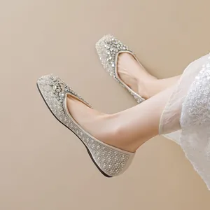 Elegant pointed toe flat bridal shoes with sparkling rhinestones and pearls in beige finish