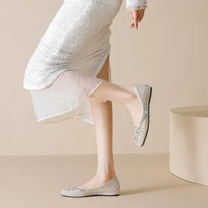 Elegant pointed-toe champagne mesh flat shoes with rhinestones and pearl embellishments