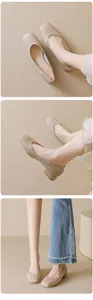 Detail view of beige square-toe block-heel pumps with vintage matte leather texture