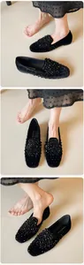 Detailed view of black velvet ballet flats with intricate rhinestone and bead embellishments