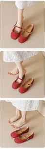 Detail view of red suede Mary Jane flats with adjustable buckled straps for women
