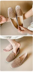 Detailed view of champagne velvet ballet flats with shimmering crystal beads and sequins