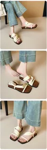 Close-up of cream woven knot straps and square toe detail on casual flat sandals