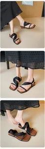 Detail showing the black ribbon straps and brown platform sole on vintage square toe sandals