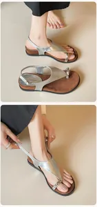 Detail of silver metallic toe-ring sandals featuring adjustable heel straps and buckles