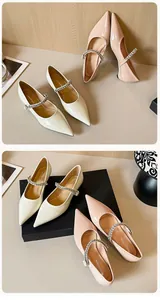 Detail showing pointed toe pumps with shiny patent leather and rhinestone straps