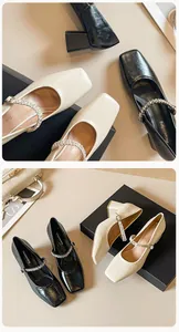 Detail of square toe Mary Jane pumps with rhinestone chain and chunky heels