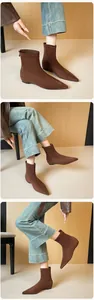 Detail of brown suede pointed toe ankle boots with metal back zippers for women