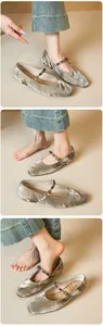 Macro detail of silver velvet Mary Jane flat shoe with golden buckle and bead accent