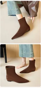 Detail showing high-quality dark brown suede sock boots with elegant pointed toe and back zipper
