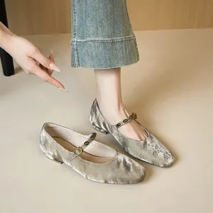 Silver velvet Mary Jane flats with square toe and buckle strap on model wearing denim