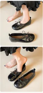 Close-up of black ballet flats featuring pleated drawstring details and bow accents