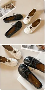 Detail of soft leather ballet flats with elegant pleated toe and bow tie decoration