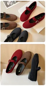 Detailed close-up of round toe Mary Jane flats in red, brown, and black suede textures